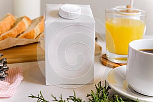 Blank half liter milk box tetra pack  with lid on a table with breakfast. package template, mockup of a retail container for