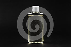blank hand sanitizer over black background. copy space. covid-19 symbol concept