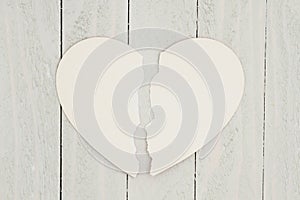 Blank heart-shape card on weathered wood background