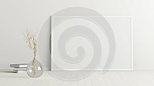 Blank horizontal poster frame mock up standing on white floor next to white wall with vase and books. Clipping path around poster.
