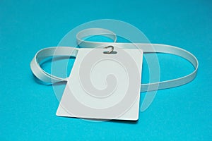 Blank identification card with white neckband isolated on blue background, space for text