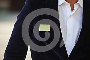 Blank identity tag hanging from a business man suit
