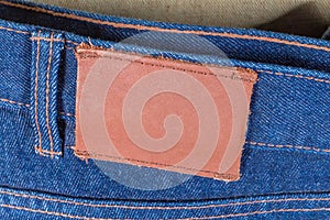 Blank leather label sewed on waistband of the blue jeans