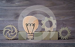 Blank letter blocks with cogwheels and a light bulb shape