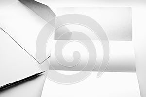 blank of letter paper and white envelope with pen