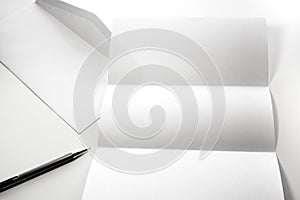 blank of letter paper and white envelope with pen