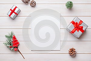 Blank magazine on whiite wooden table surrounded by Christmas gifts and decorations photo