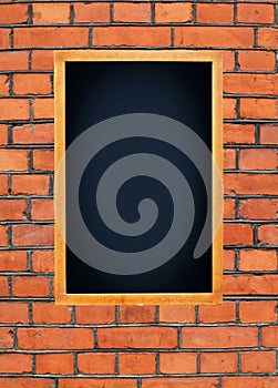 Blank menu board hanging on brick wall