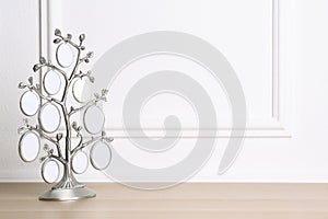 Blank metal family tree frame on table. Space for text