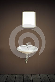 Blank mirror and basin and wooden flloor in vintage style