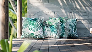 Blank mockup of a set of outdoor pillows featuring a tropical leaf pattern in shades of green and blue.