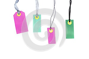 Blank multicolored labels tags made of cardboard or price notes of pink and green color isolated on white background.