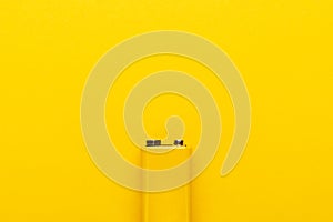 Blank nine-volt battery on the yellow background with copy space
