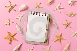 Blank note book with starfish or seashells on a pink background , summer vaction concept