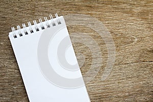 Blank note paper on brown wood background