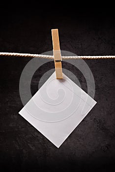 Blank note paper hanging on rope with clothes pins