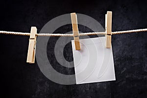 Blank note paper hanging on rope with clothes pins