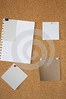 Blank note paper over a corkboard