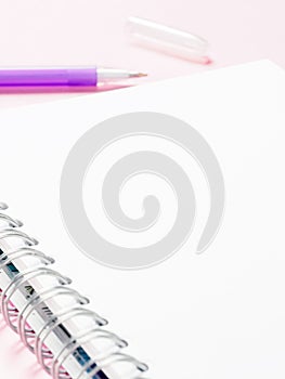 Blank note with pen on pink background