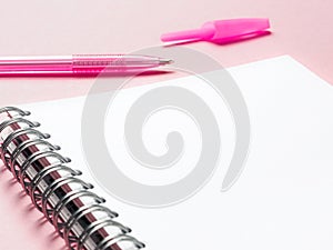 Blank note with pen on pink background