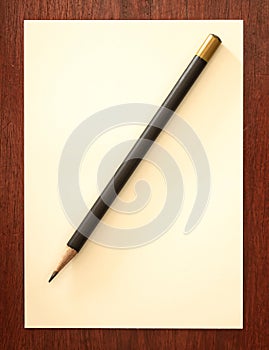 Blank notebook with brown pencil on wooden table