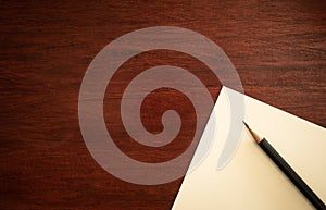 Blank notebook with brown pencil on wooden table