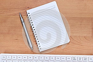 Blank notebook and computer keybord on the desk photo