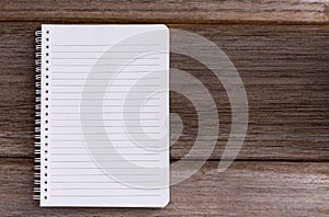 Blank notebook isolated on wood table background  with copy space for your text or image