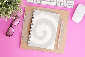 Blank notebook with keyboard and pencil on pink background, Flat lay photo of notebook for your message