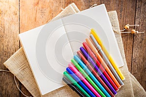 Blank notebook with many color markers