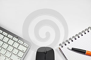 Blank notebook with pen and keyboard in the office