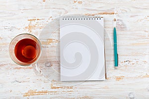 blank notebook with pen on white wooden table