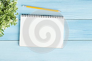Blank notebook with and pencil on blue background,Flat lay photo