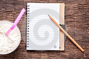 Blank notebook with pencil and cocoa milkshake