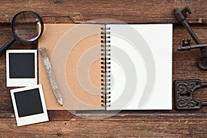 Blank notebook with pencil, key and magnifying glass