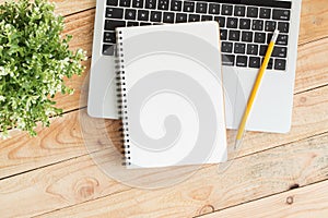 Blank notebook with and pencil on laptop,Flat lay photo of notebook for your message