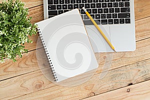 Blank notebook with and pencil on laptop,Flat lay photo of notebook for your message