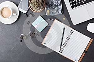 Blank notebook with pencil on office black desk table