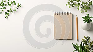 A blank notebook with a pencil and a small plant on a white background.