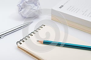 Blank notebook with pencil on white background