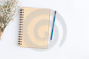 Blank notebook with and pencil on white background, Flat lay photo of notebook for your message, Top view of note book brown open