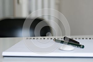 Blank notebook with pencil on white desk background,pencil and notebook with space for text or image, selective focus.