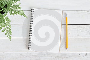 Blank notebook with and pencil on white wood,Flat lay photo of notebook for your message