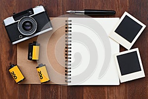 Blank notebook with photo film, photo frames and camera