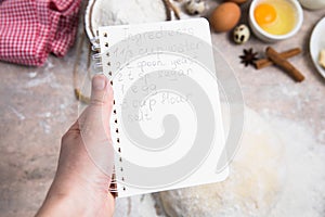 blank notebook for recipes in child hands/