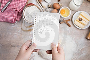 Blank notebook for recipes in child hands/