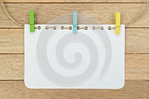Blank notebook sheet with rope on wood background