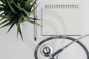 Blank notebook with stethoscope white background. heart and healthcare concept. diagnostic, disease, cardiology. equipment
