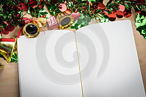 Blank notebook on wood table with christmas decorations