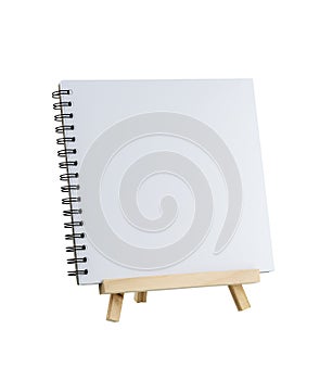 Blank notebook on wooden tripod standing isolated on white background